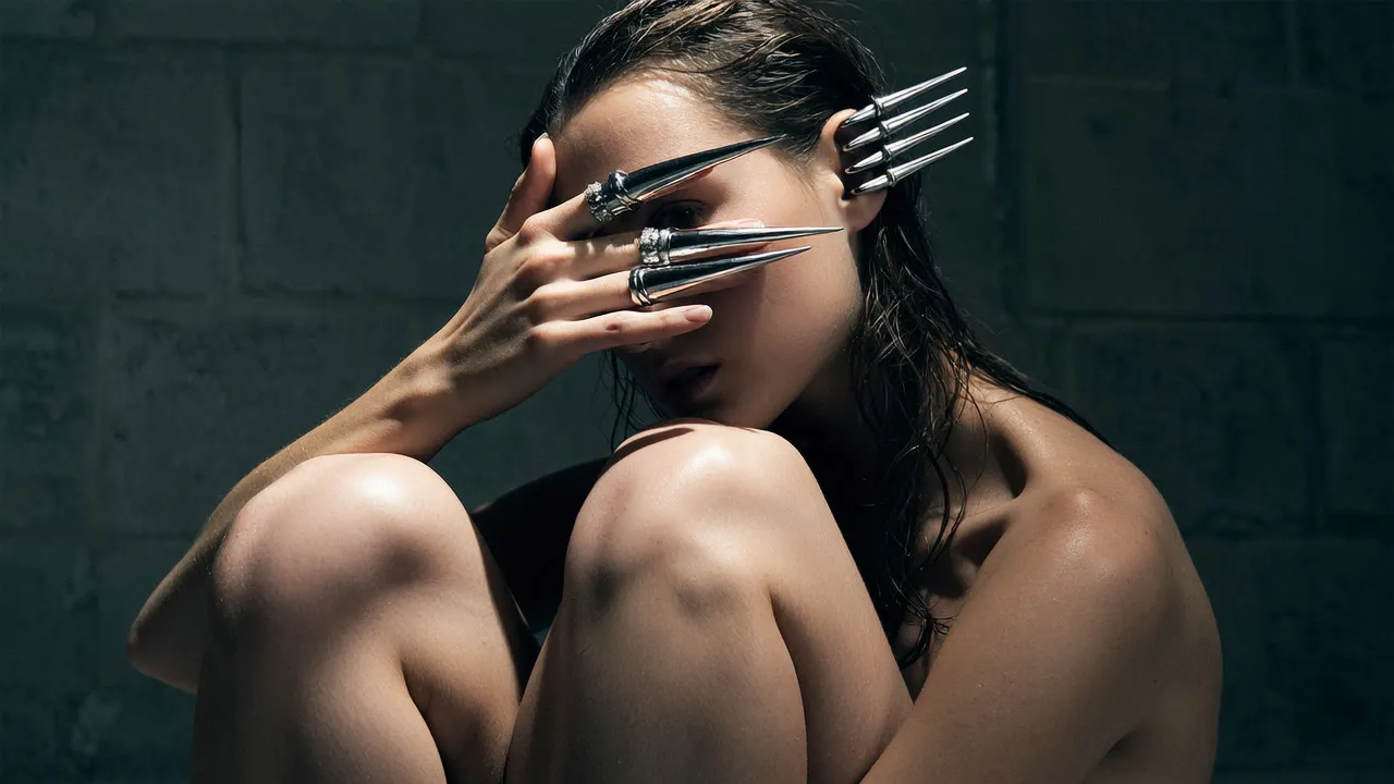 Black and grey: steel claws across a face, knees drawn up