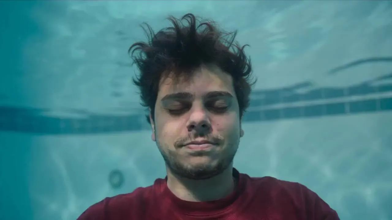 A man holding his breath underwater